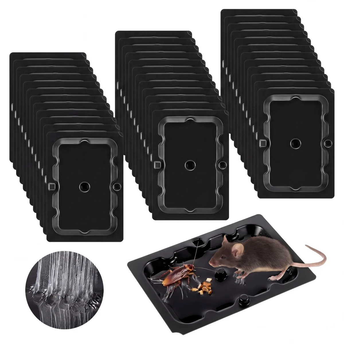 Four black rectangular sticky traps on a flat surface