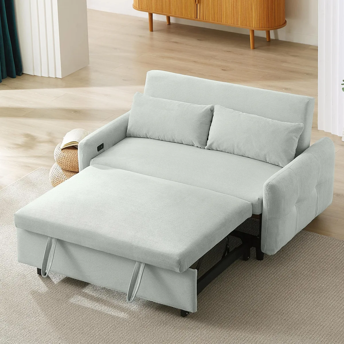 Light grey-green corduroy pull-out sofa bed with two throw pillows