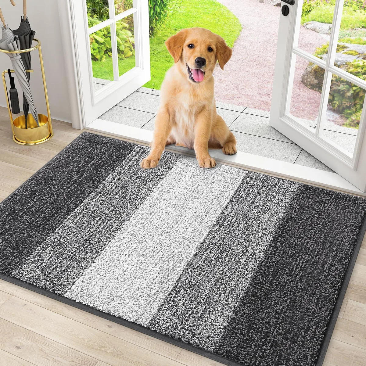 Grey striped door mat, low-profile rectangular shape, machine-made polyester surface with braided edges, non-slip rubber backing