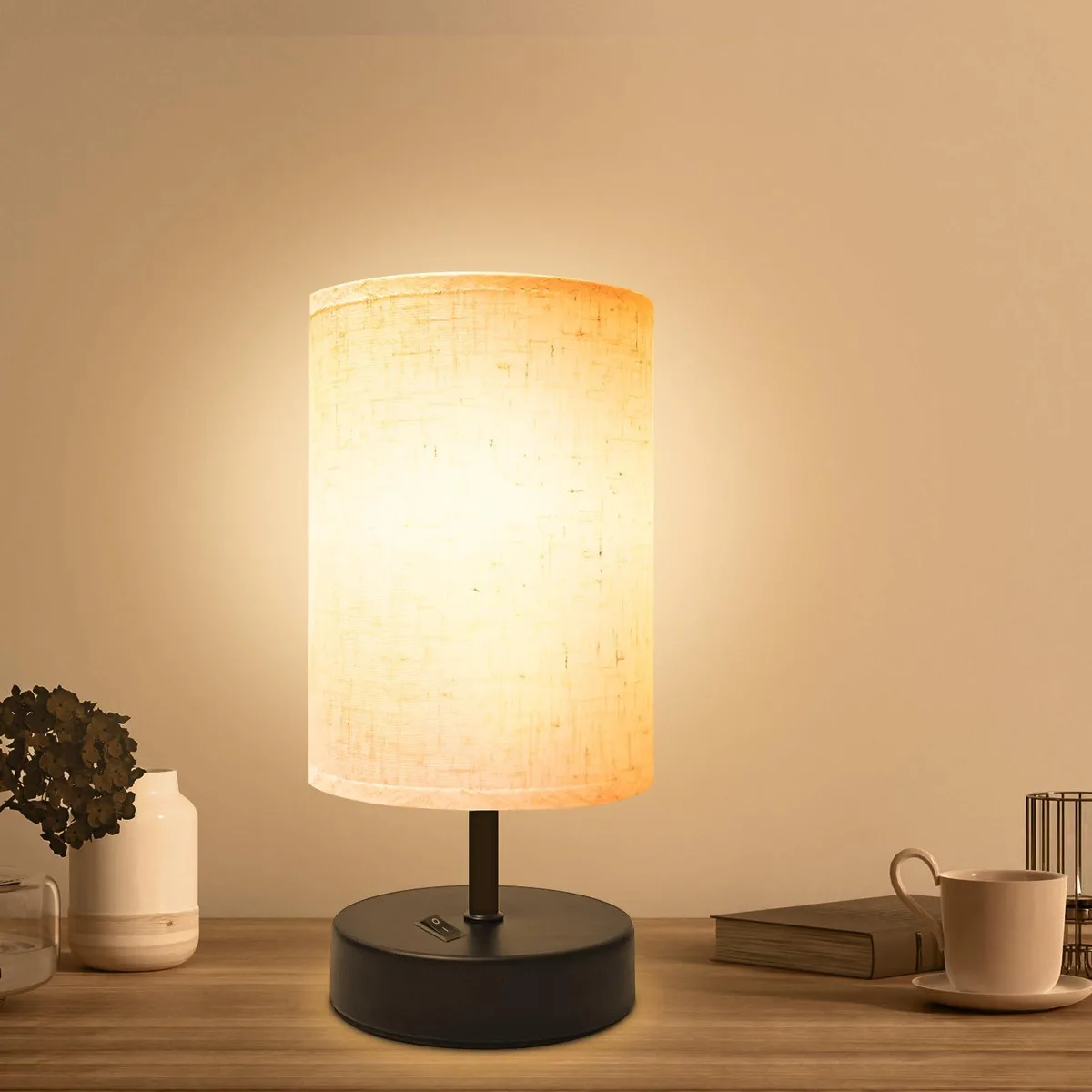 Small round flaxen fabric shade on black painted base, 9 inch height