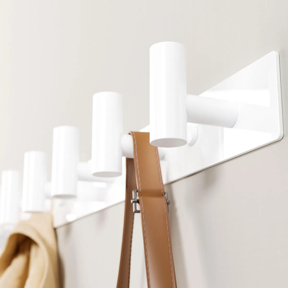 White painted stainless steel coat rack with five T-shaped hooks on a 16.5 inch rail