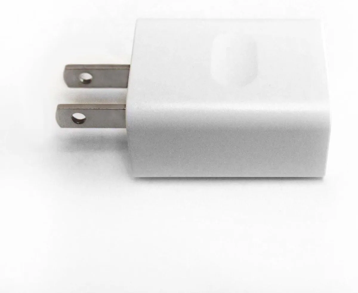 Compact black wall wart with US two-pin prongs and barrel-tip output lead