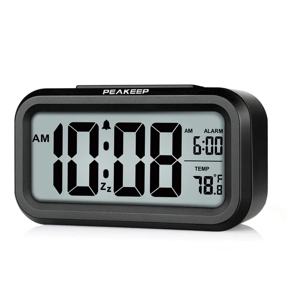 Small black rectangular digital clock with LCD screen and top-mounted snooze button