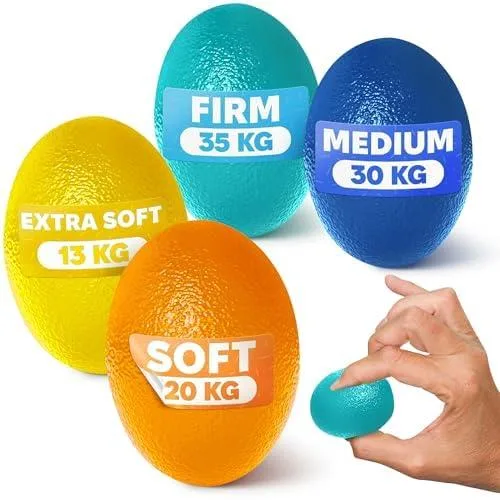 Four coloured therapy balls on a flat surface