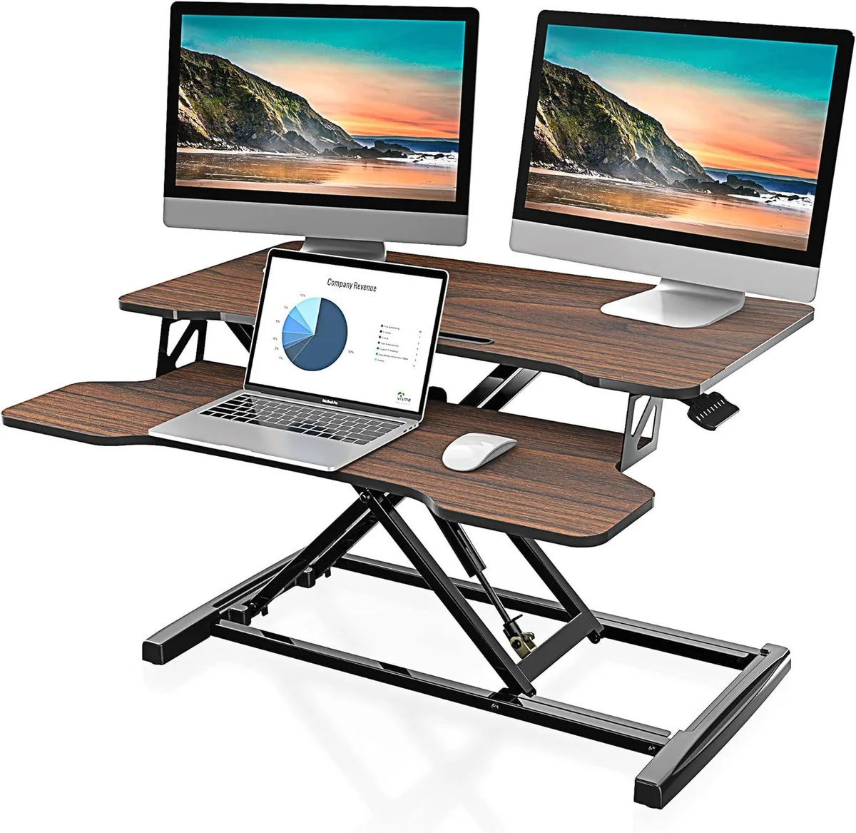 Brown standing desk converter on a desk, rectangular top, black frame, gas springs visible