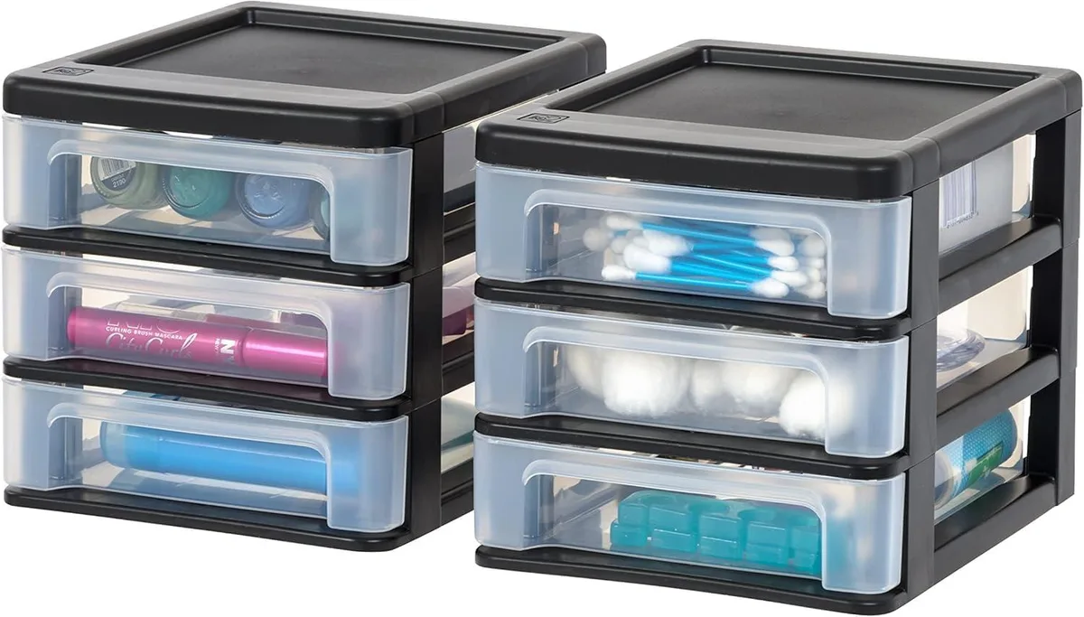 Two small black plastic stackable three-drawer units with clear drawers