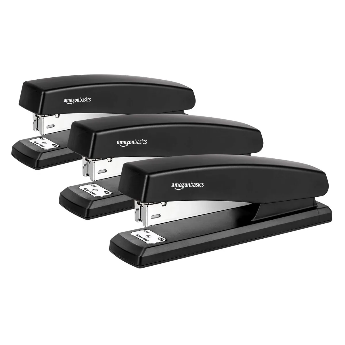 Three black desktop staplers with rubber bases and included staples