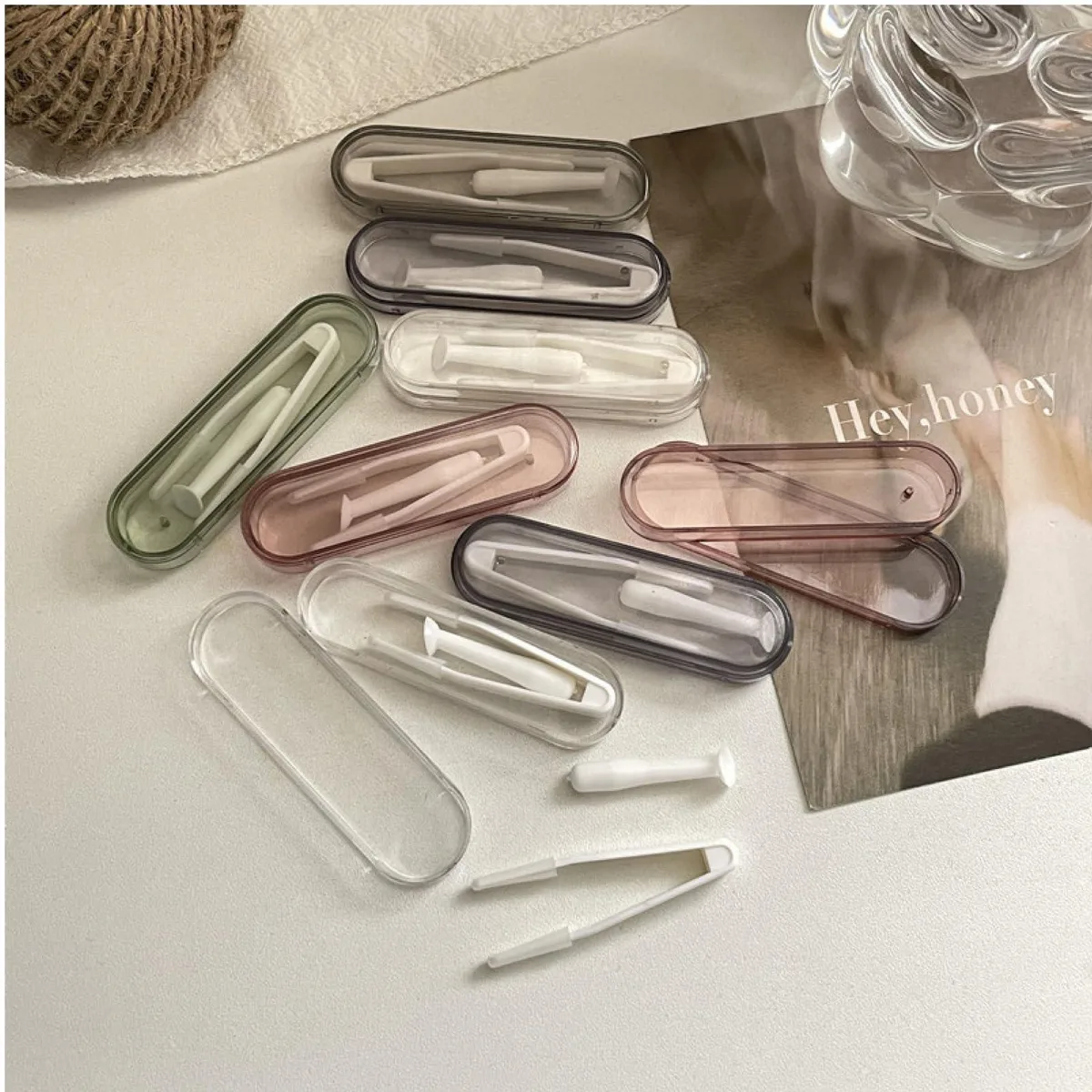 Black contact lens tool kit with ten cases each holding an inserter remover and soft tip tweezer