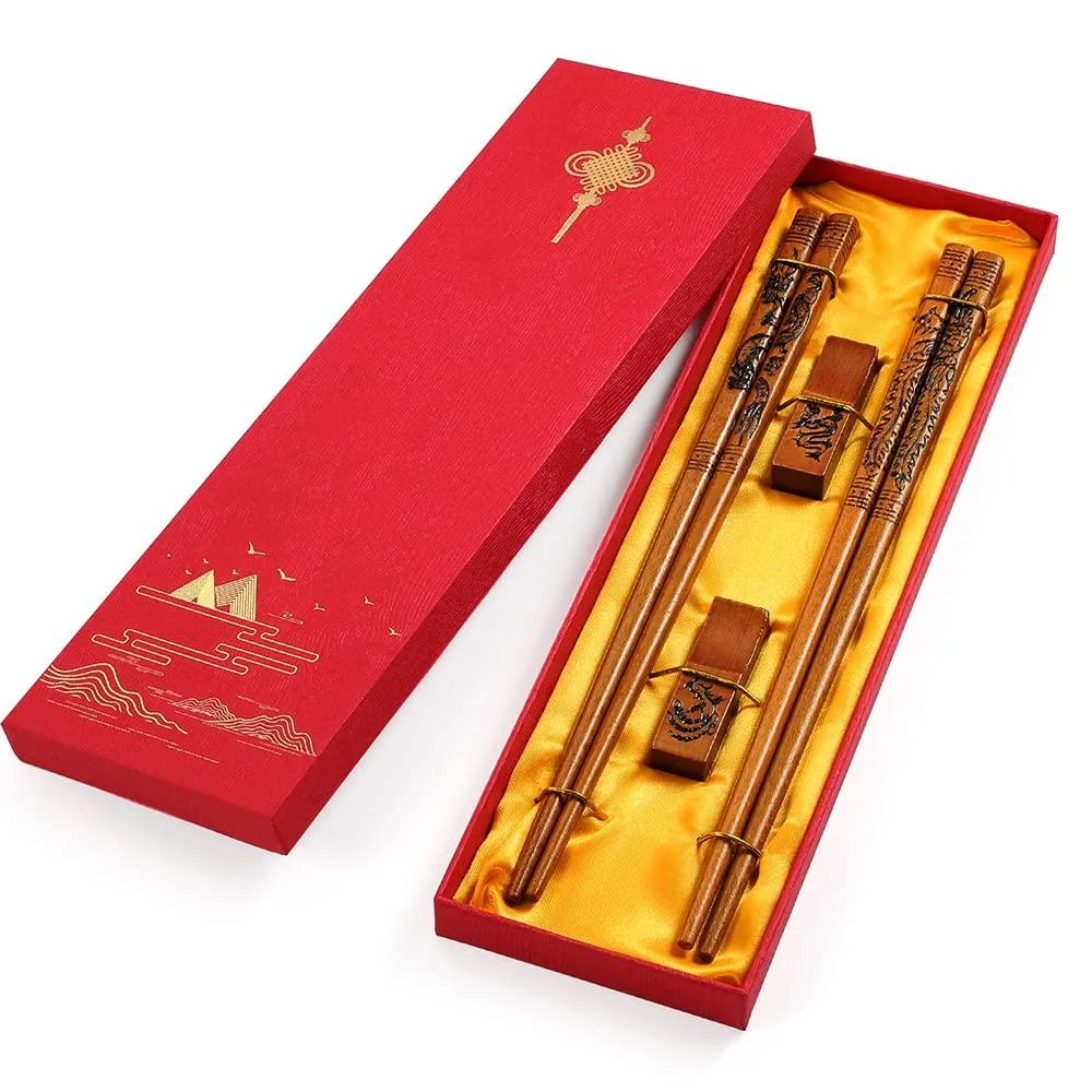 Red wooden chopsticks with dragon and phoenix carvings in a Chinese knot gift box