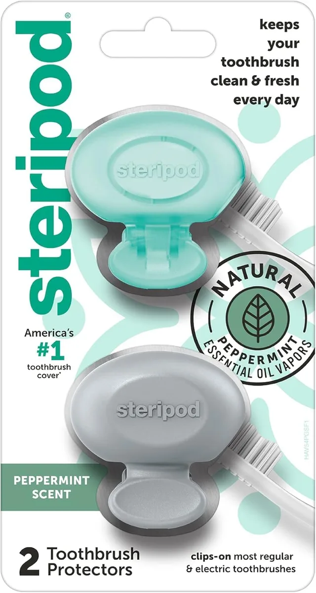 Two white clip-on toothbrush protectors with peppermint tablets