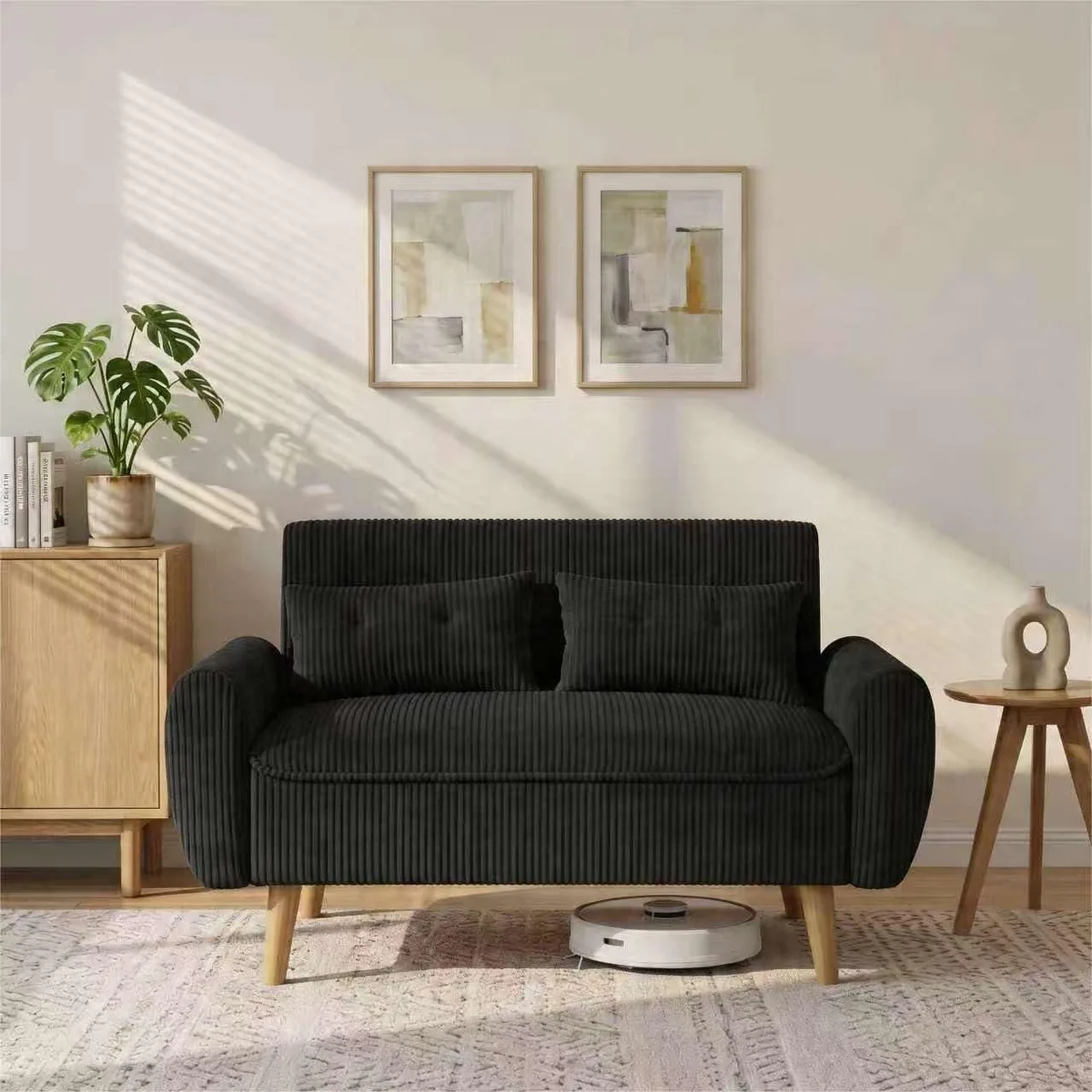 Black cotton loveseat with deep cushions, wood legs, two pillows, compact 48-inch frame