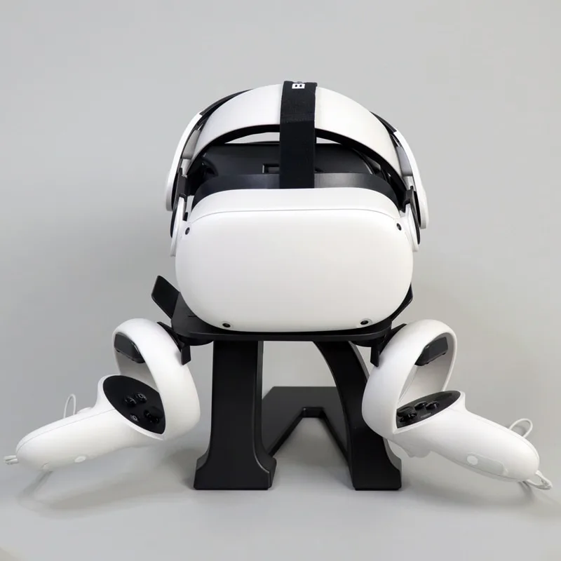 Black VR display stand with round textured base, vertical pole, headset cradle and two controller brackets