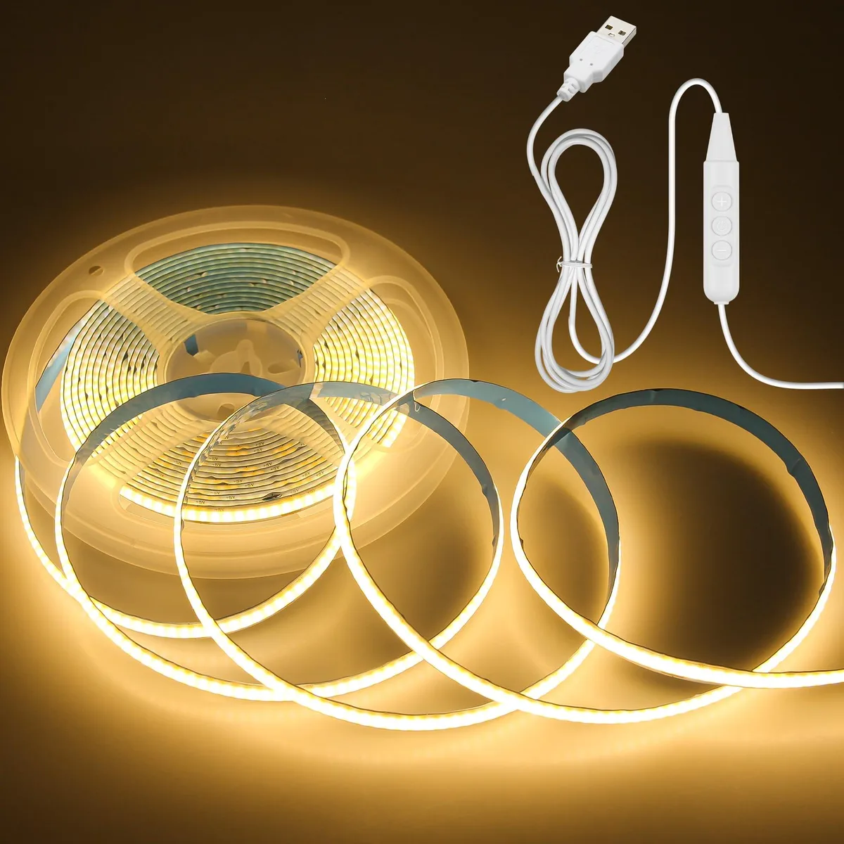 A 5 metre warm-white COB LED strip on a reel, 8 mm wide white silicone, USB plug and inline dimmer