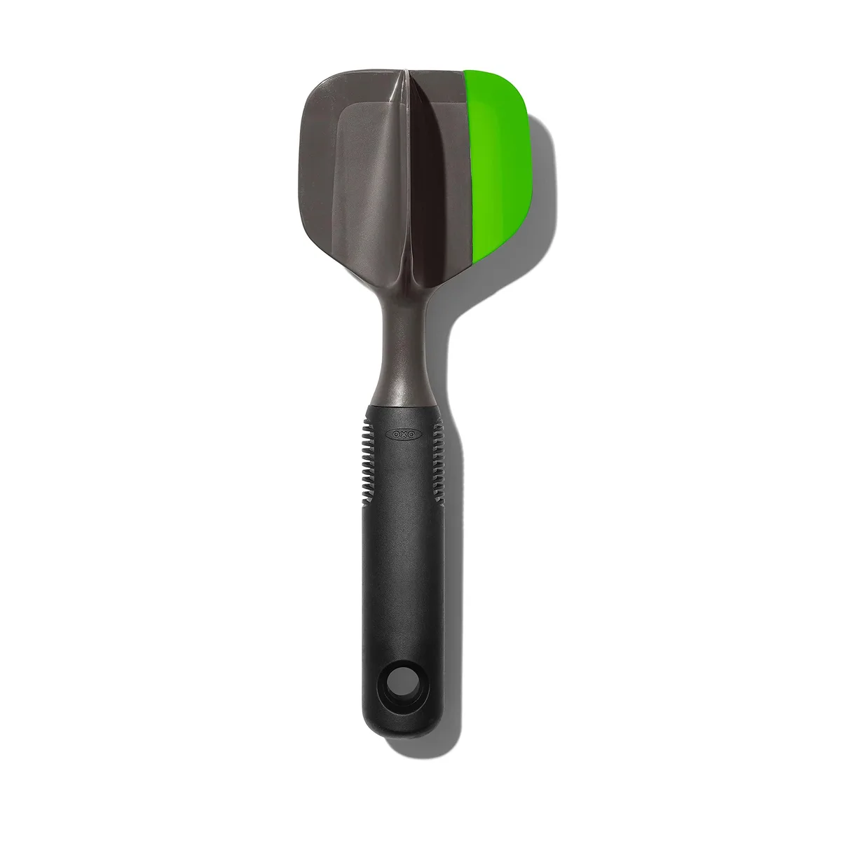 Green plastic avocado scoop and masher with textured grip