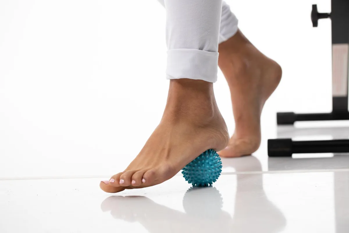 A small round vibrating massage ball with silicone spikes and USB charging port
