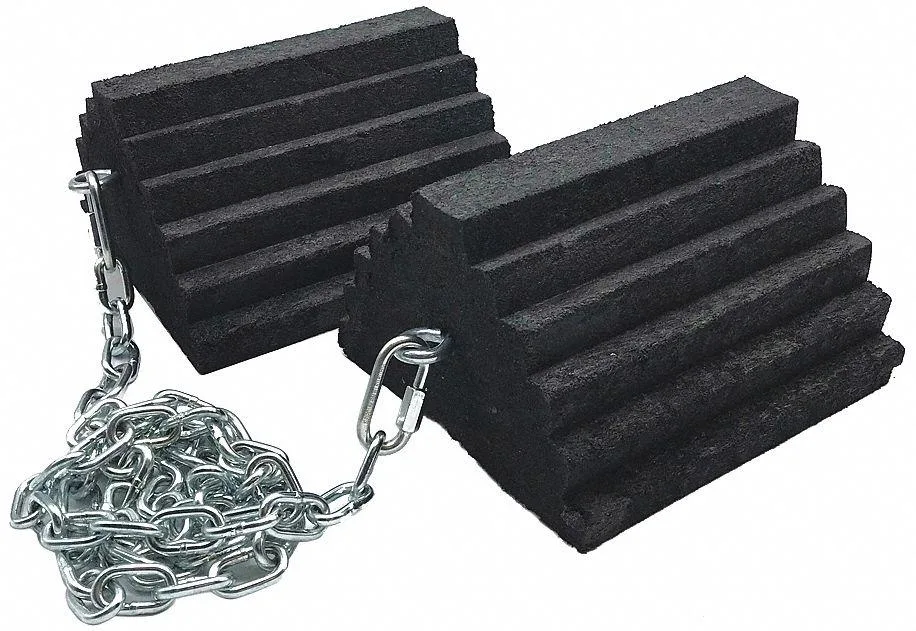 Pair of black rubber wheel chocks with grooved tread and connecting chain