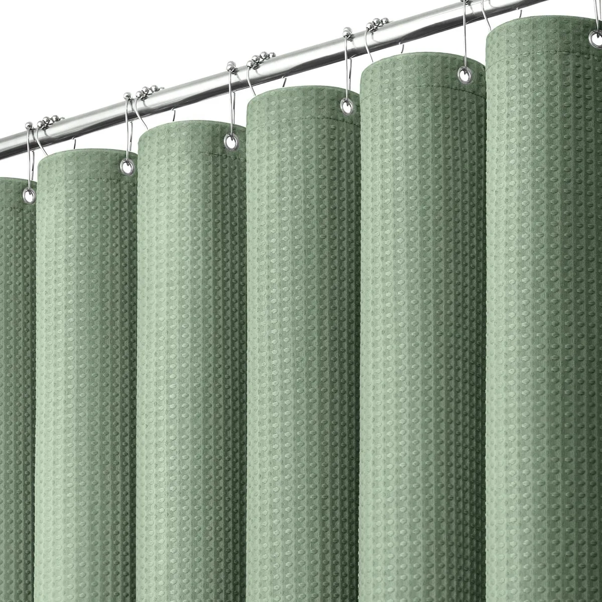 Sage green waffle-textured polyester shower curtain with weighted hem and 12 plastic hooks