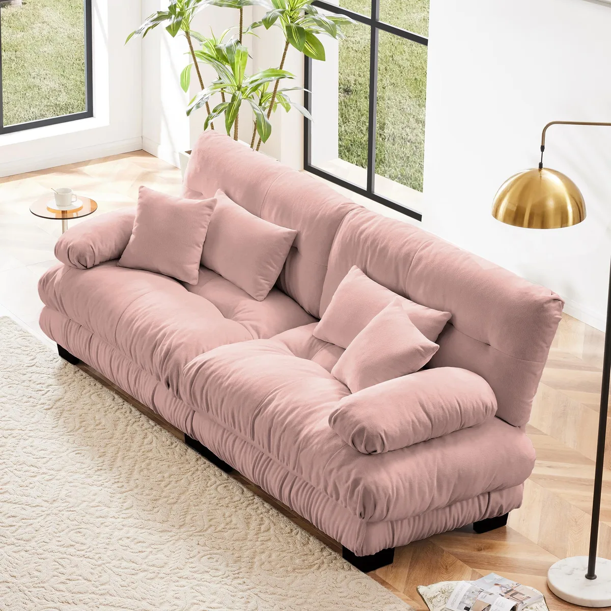 Pink chenille two-seater sofa with round bolster arms, two lumbar and two throw pillows