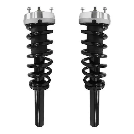 Two silver metal front strut assemblies with black coil springs, top mounts and hardware, new in box