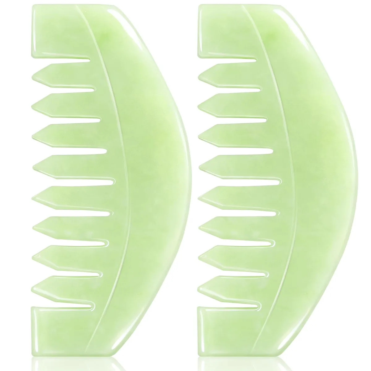 Two smooth jade combs, 8.7 cm long, pale green stone