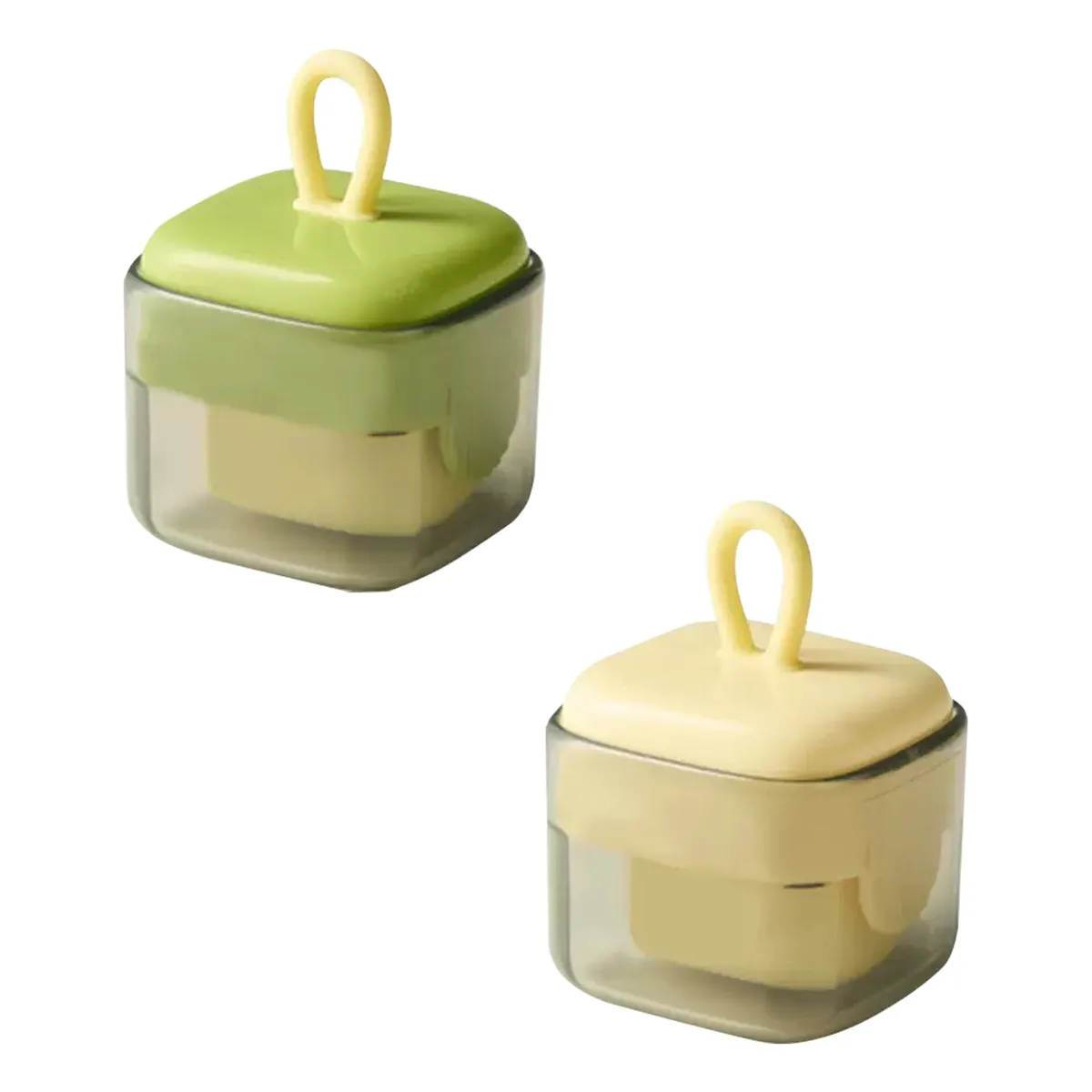 Two small cube-shaped lint removers with dust covers, light-coloured plastic finish