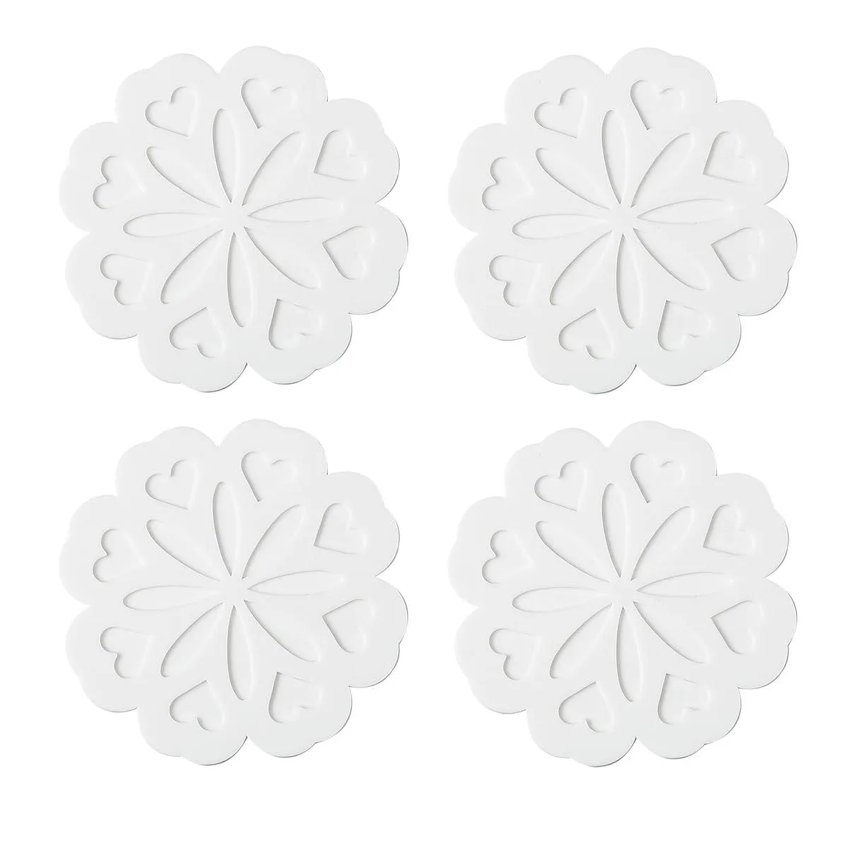 Four white round silicone trivets with a carved vintage design, flexible and heat-resistant up to 482°F
