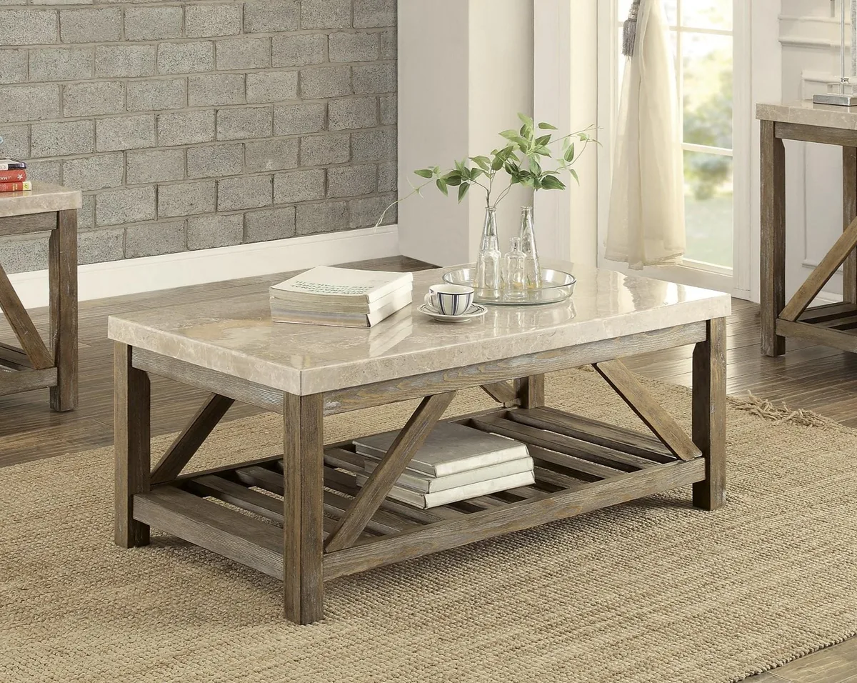 Creamy white marble top coffee table with angled wood supports and lower shelf
