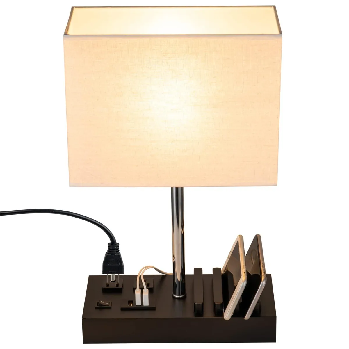 Black rectangular fabric-shade table lamp on wooden base with three slots and integrated outlets