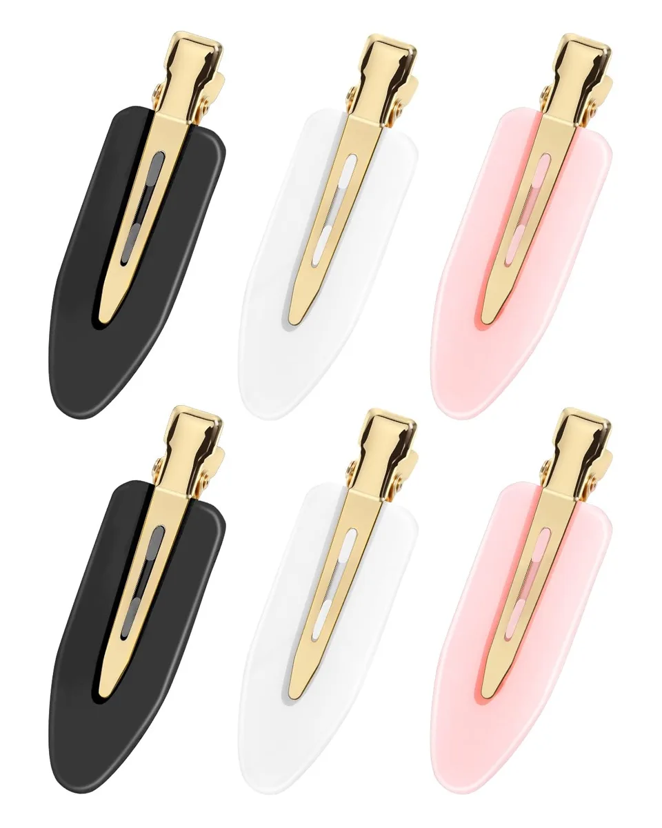 Six flat hair clips with gold metal handles and plastic bodies