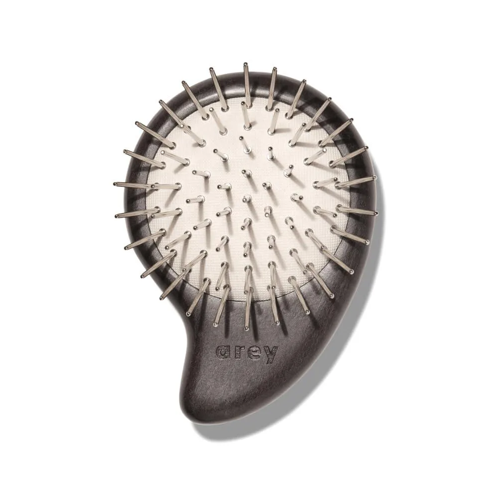 White ergonomic scalp brush with metal bristles and wooden handle