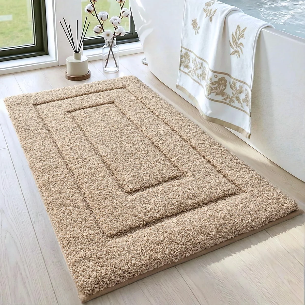Beige rectangular bath mat with plush microfiber pile and non-slip rubber backing