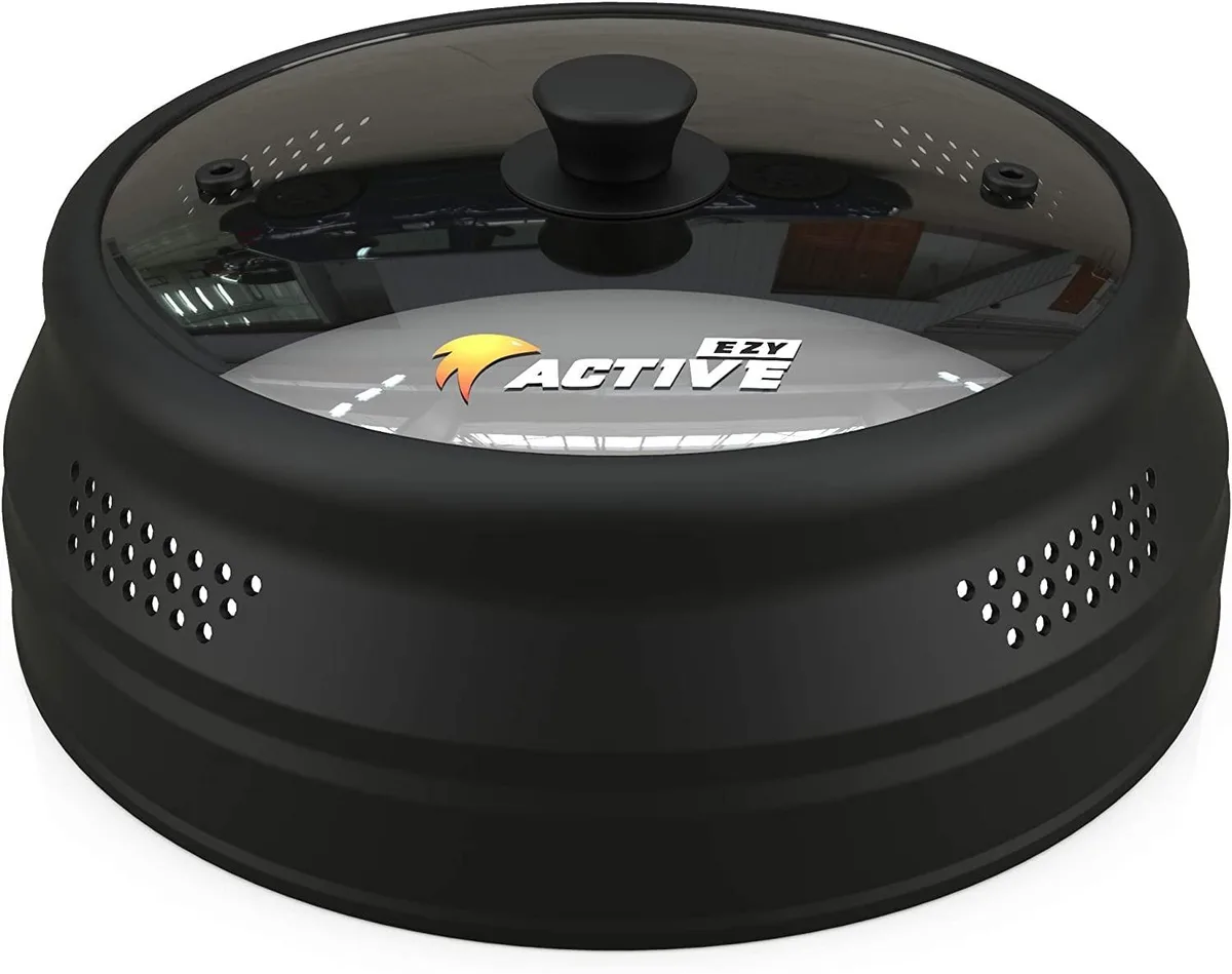 Black collapsible microwave cover with tempered glass centre and silicone rim, round 10.5 inch profile, multiple steam vents visible