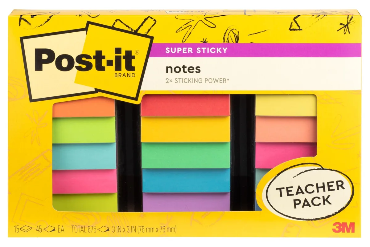 A rectangular cardboard box containing fifteen square sticky-note pads in assorted neon colours