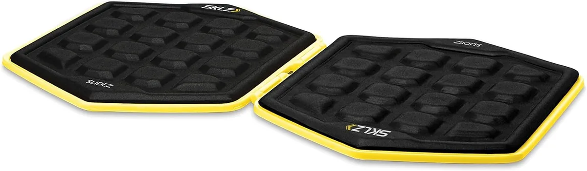 Pair of bright yellow circular exercise glider discs with textured surfaces and integrated clip fasteners