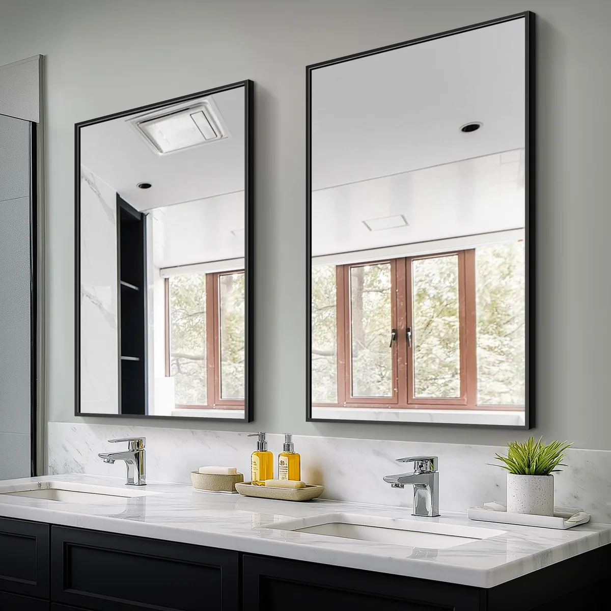 Two rectangular bathroom mirrors with black metal frames, each 36 by 24 inches