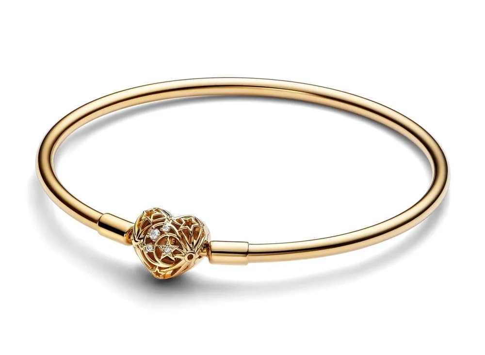 Gold-plated open bangle with heart clasp featuring moon and star details and sparkling stones