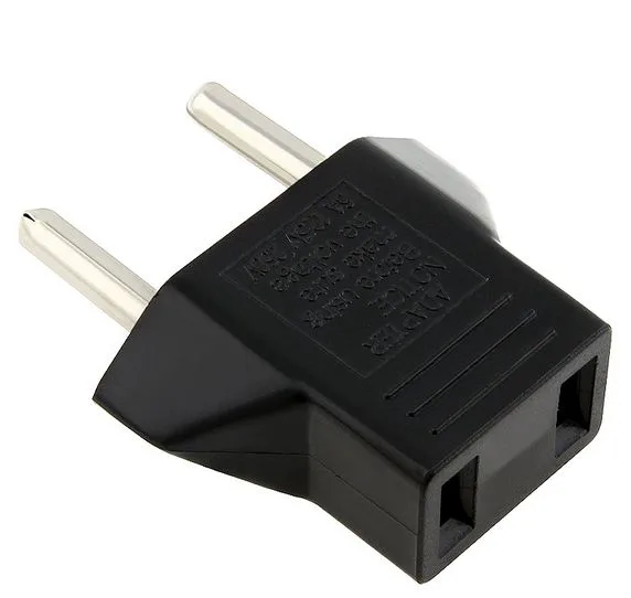 Five black US-to-EU plug adapters shown together