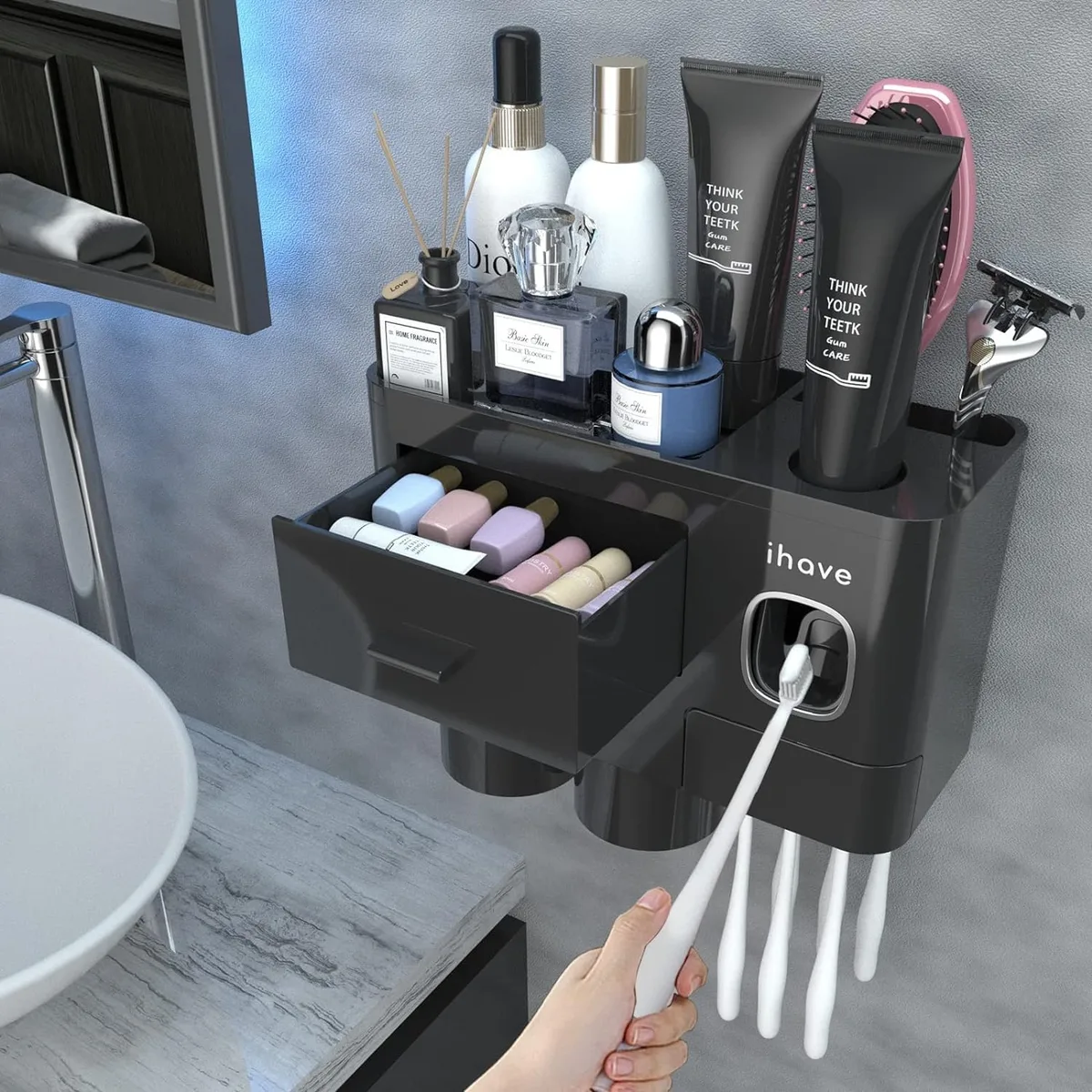 White wall-mounted bathroom organiser with toothpaste dispenser, two magnetic cups and toothbrush slots