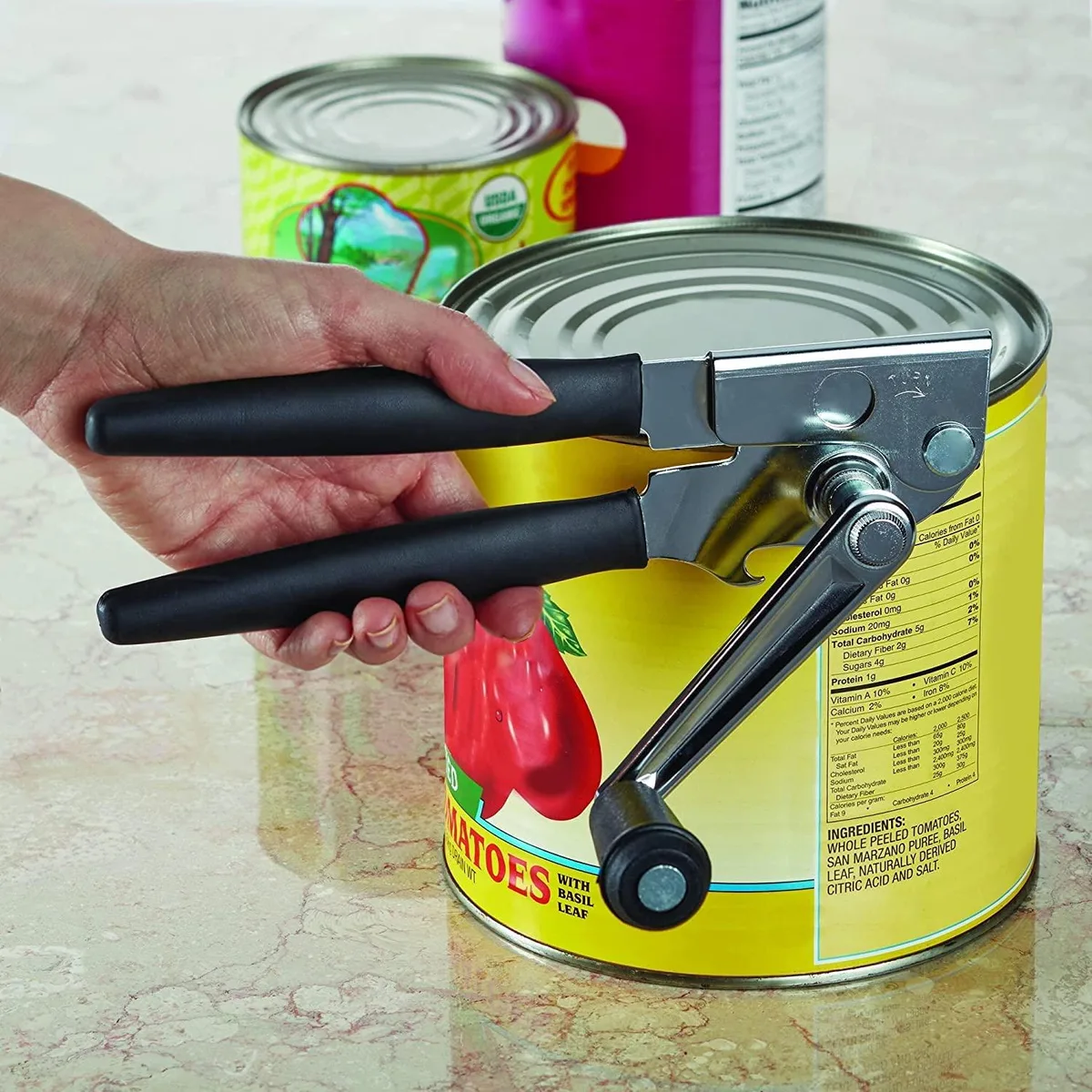 Silver manual can opener with black cushioned handles and crank, compact rectangular shape