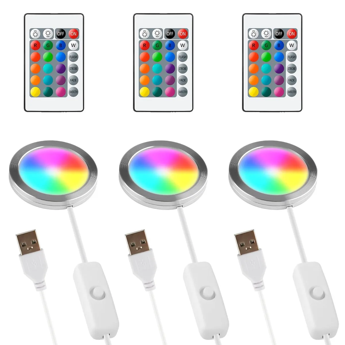Three small plastic cubes with USB cables and remote controls