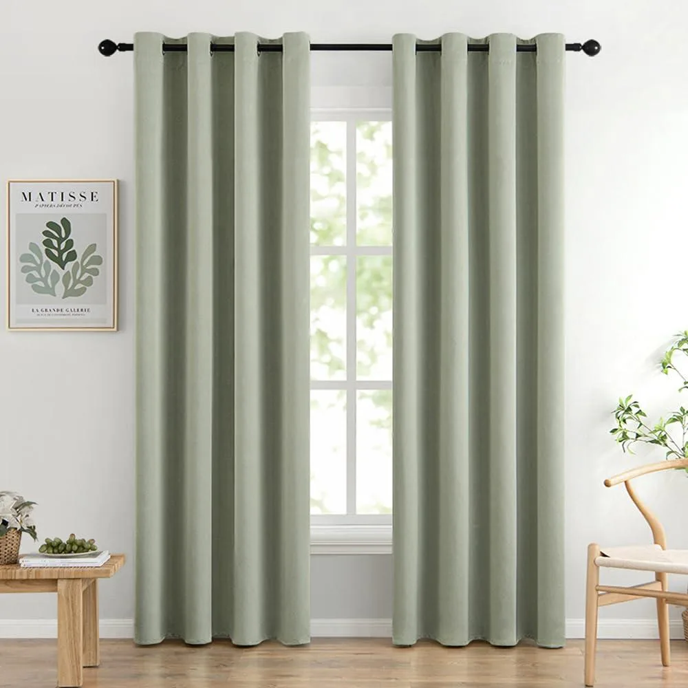 Two sage green blackout curtain panels with silver grommets, 52 by 84 inches