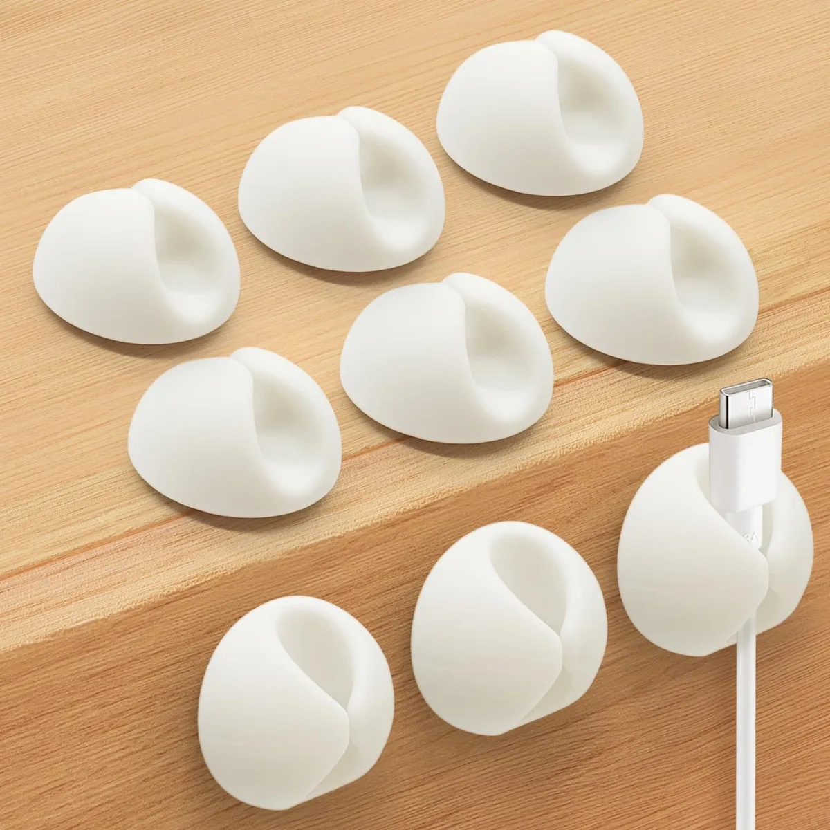 Nine small white silicone clips with adhesive backs, each 1.1 by 0.6 by 0.1 inches
