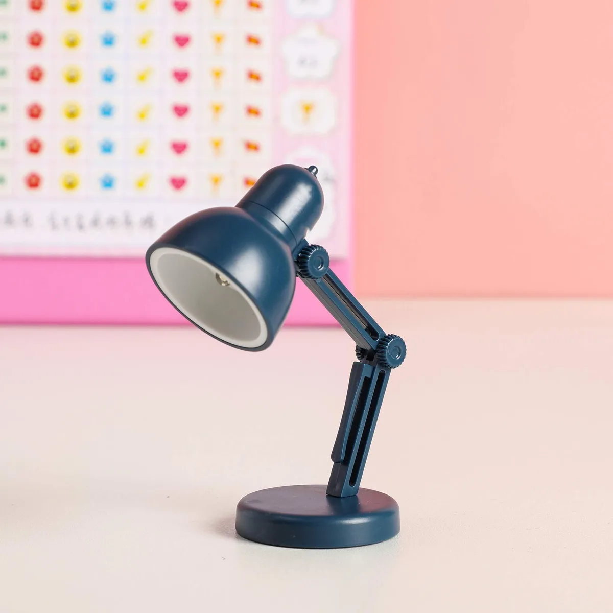 Two small blue clip-on LED book lights with flexible necks and magnetic bases, shown side by side