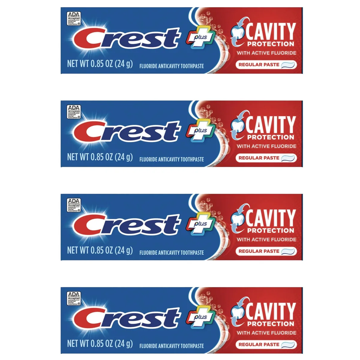 Four small white Crest toothpaste tubes in a row