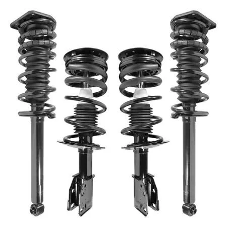 Four silver strut assemblies with springs and mounts on a pallet