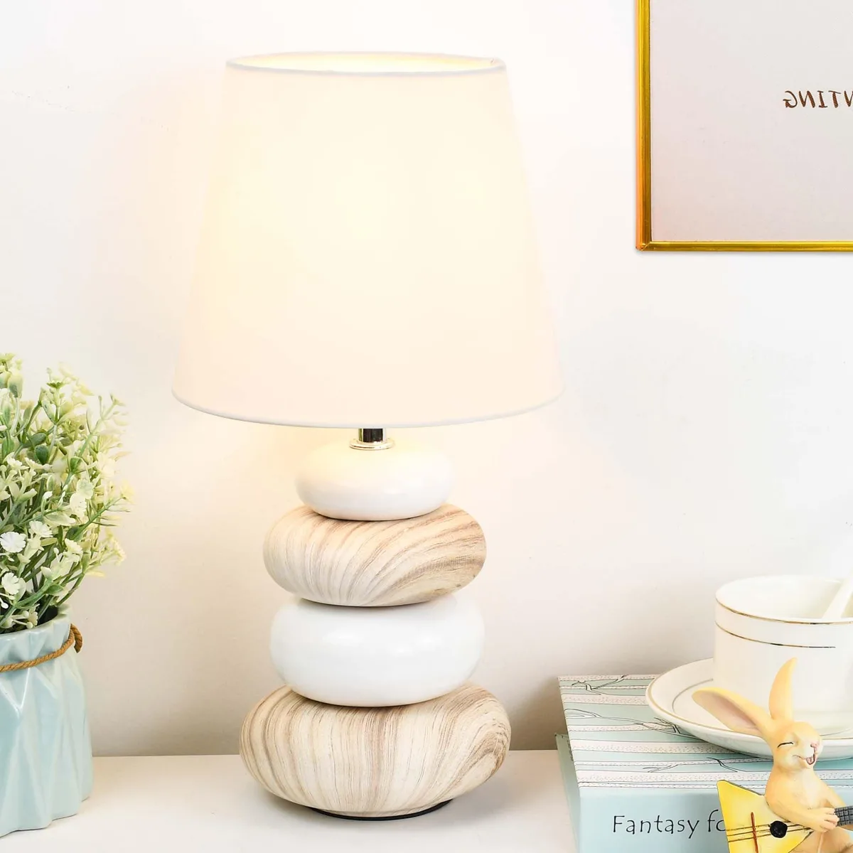 Small light-wood ceramic table lamp with off-white fabric shade, barrel shape, 6.5 by 12.44 inches