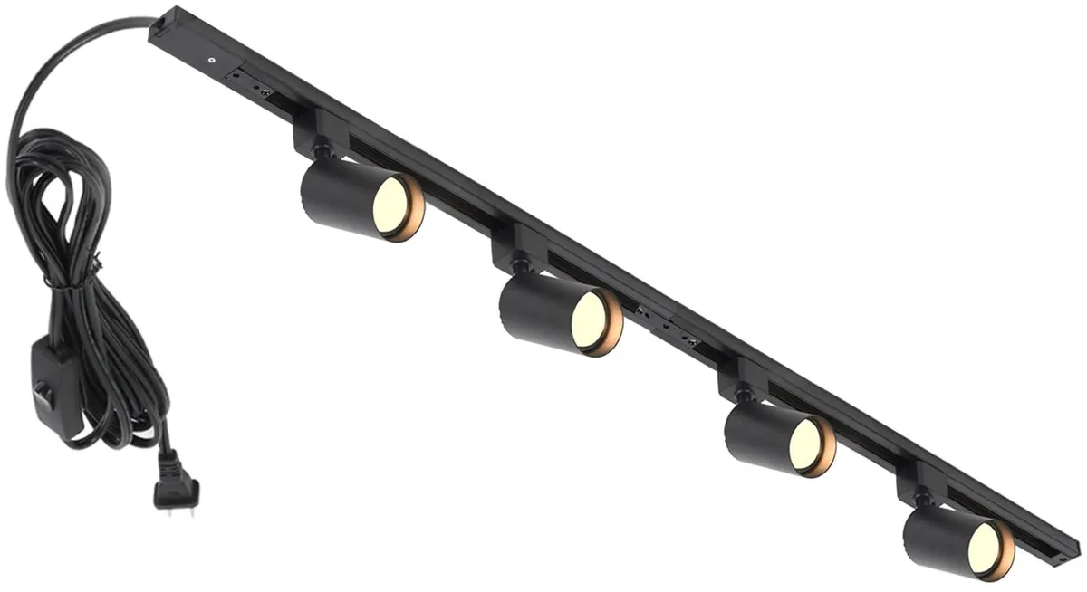 Black metal track rail with four adjustable spot heads and a long cord