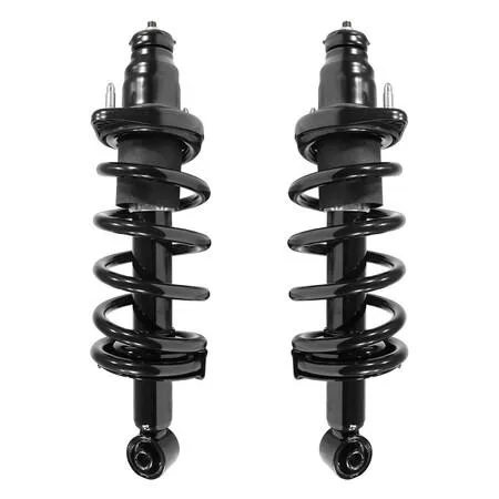 Two silver rear strut assemblies with coil springs and top mounts, new in box