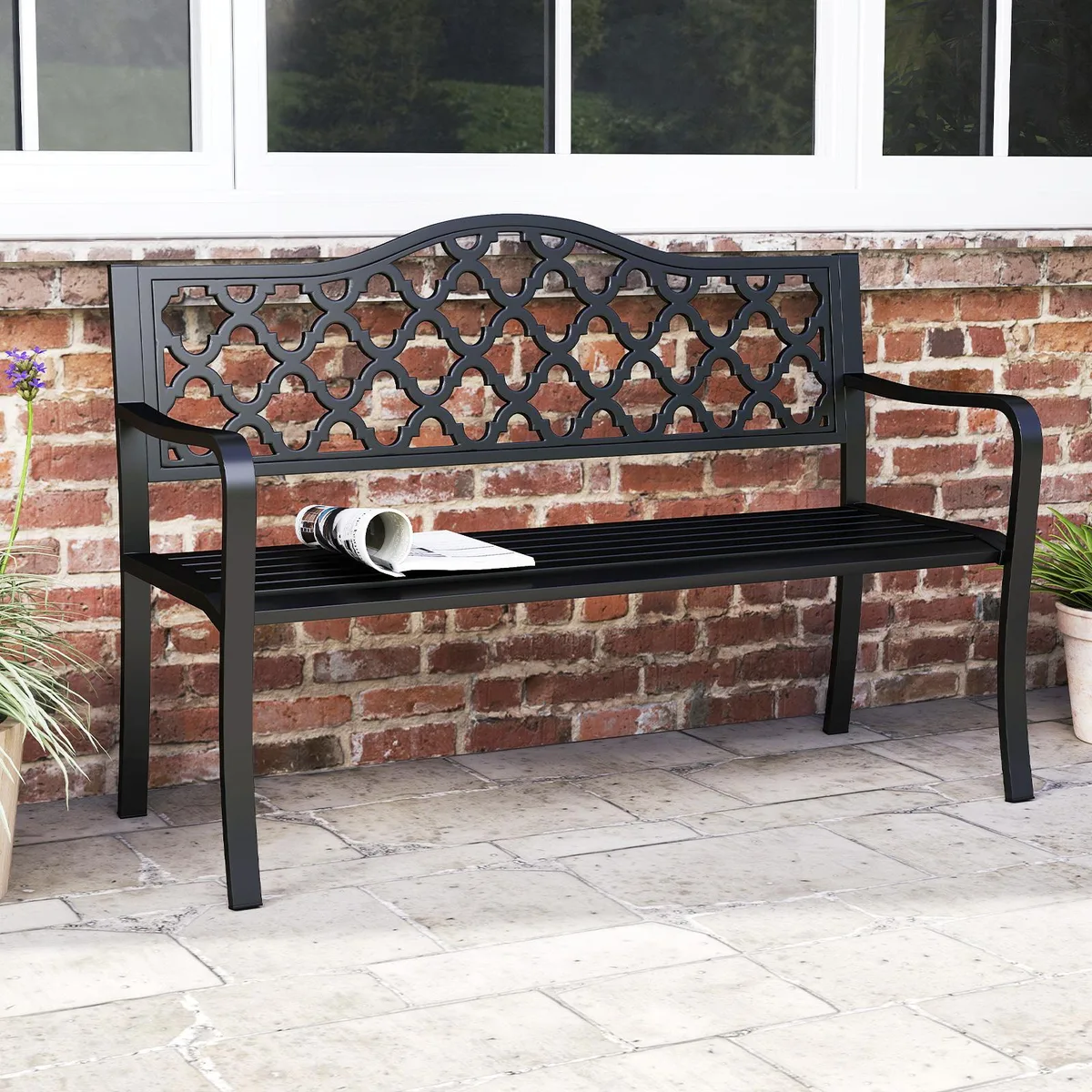 Black patio bench with curved armrests and patterned backrest on metal frame