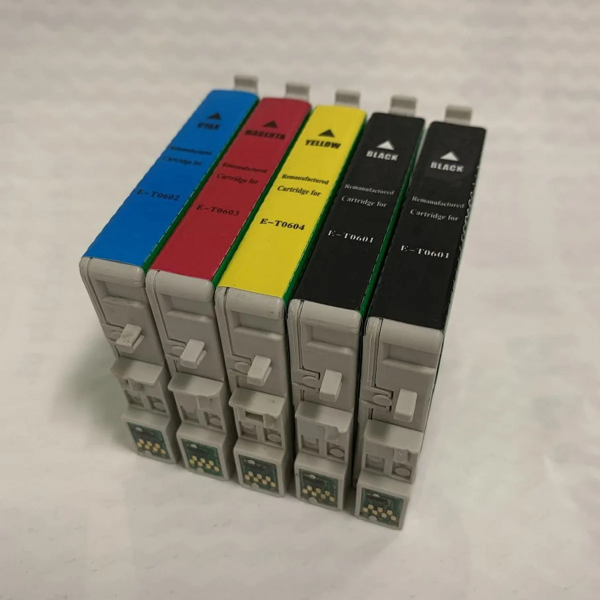 Five ink cartridges in black cyan magenta yellow packaging